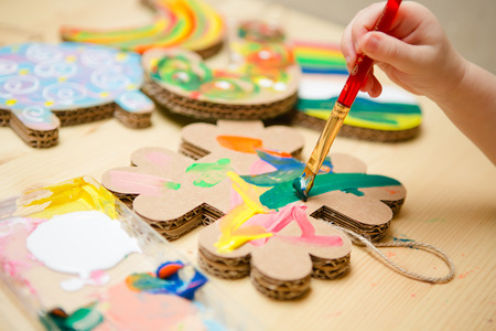 Little female baby painting with colorful paints. selective focusの写真素材