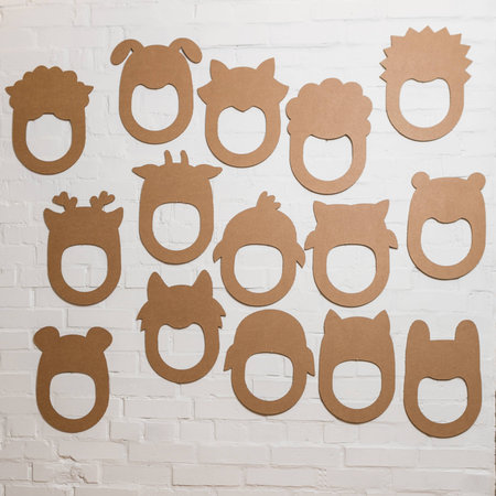 Set of cardboard masks on a white brick wall. Consept card.の写真素材