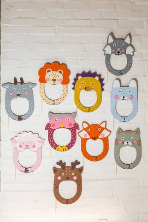 Set of cardboard masks on a white brick wall. Consept card.の写真素材