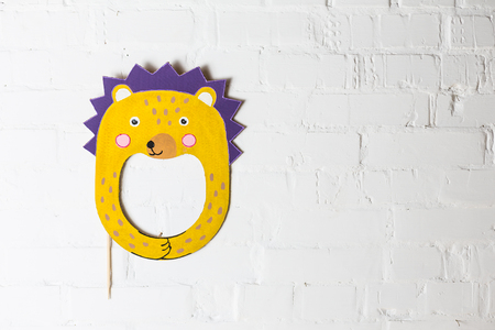 Bright cardboard mask on a white brick wall. Consept card. Hedgehogの写真素材