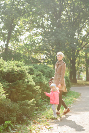 Beautiful Mother And Baby outdoors. Nature. Beauty Mum and her Child playing in Park together....