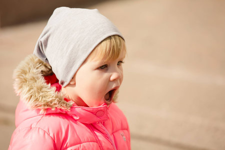attractive little girl on outdoor playground equipmentの写真素材