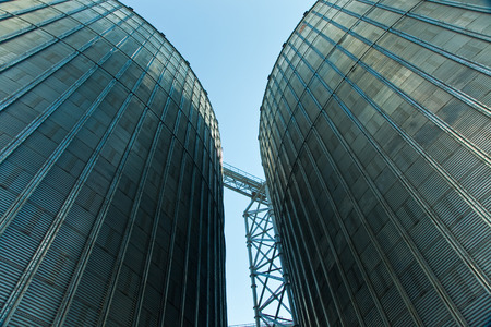 Towers of grain drying enterprise. metal grain facility with silosの写真素材