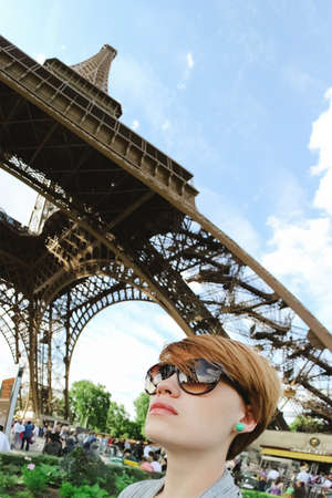 Beautiful young woman in a historic plaza in Paris, France.の写真素材