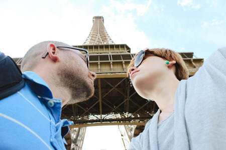 Young romantic couple near the Eiffel Tower in Parisの写真素材