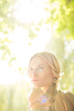 portrait of a beautiful young woman in a spring park. pictures in warm colorsの写真素材