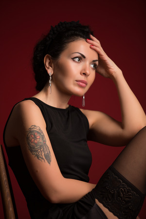 Studio portrait of a sexy brunette in black lingerie, stockingsの写真素材