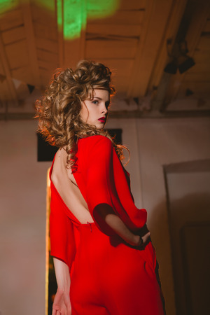 Portrait of beautiful blonde woman with red lips and curly hairsの写真素材