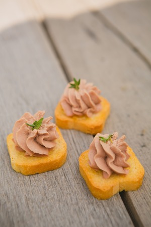 Delicious Pate Canapes on wooden background. Selective focus, shallow DOFの写真素材