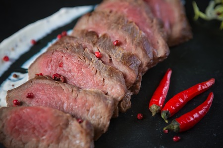 Medium Rare Cooked Beef Roast with Vegetables and Spicesの写真素材