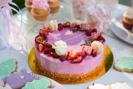 Dessert table for a party. Cake, cupcakes, sweetness and flowers. Shallow dofの写真素材