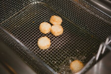 Chef is cooking appetizer with sea scallops fried in deep fatの写真素材