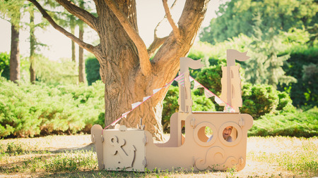Boy playing in a cardboard boat in the park. Eco conceptの写真素材