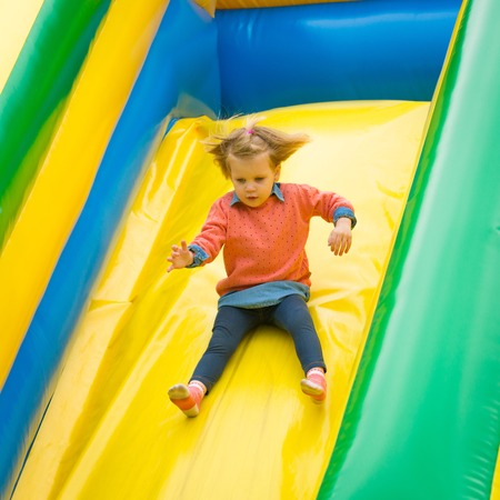 Joyful little girl playing on a trampoline.の写真素材