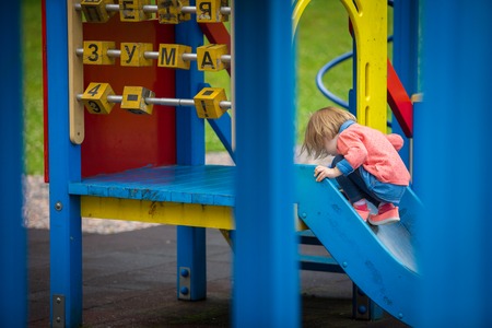 Outdoor portrait of adorable little girl playing in summer parkの写真素材