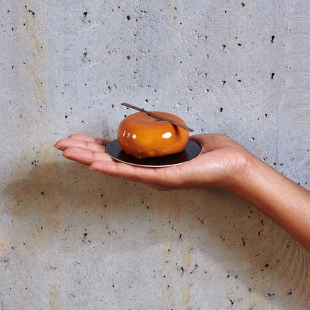 Dessert in a hand on a concrete の写真素材
