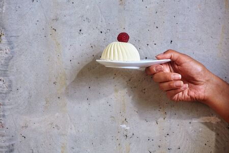 Dessert in a hand on a concrete  の写真素材