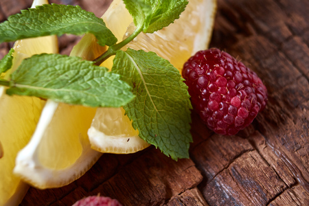 Raspberry, Mint and lemon with copy space  on wooden background.の写真素材
