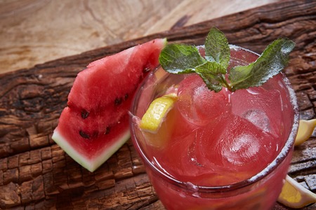 Homemade watermelon lemonade with mint and lemon in glasses and slices of watermelonの写真素材