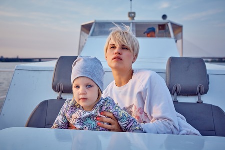 Mother, daughter on yacht or catamaran boat.  Concept of the familyの写真素材