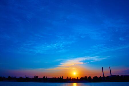 Oil refinery factory in silhouette and sunrise skyの写真素材