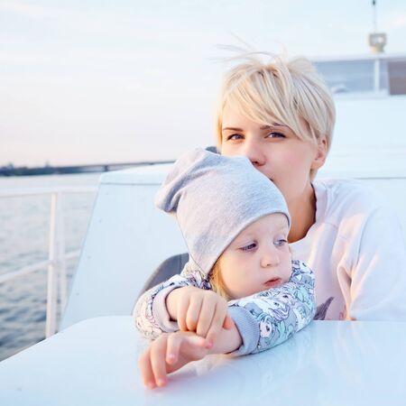 Mother, daughter on yacht or catamaran boat.  Concept of the familyの写真素材