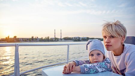 Mother, daughter on yacht or catamaran boat.  Concept of the familyの写真素材