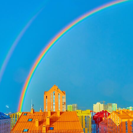 Double rainbow over bright colored houses. Kiev cityの写真素材