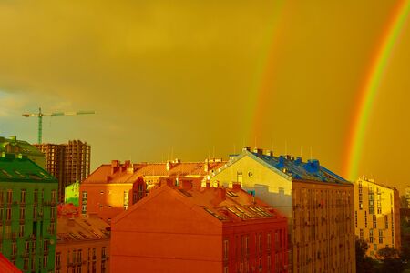 Double rainbow over bright colored houses. Kiev cityの写真素材