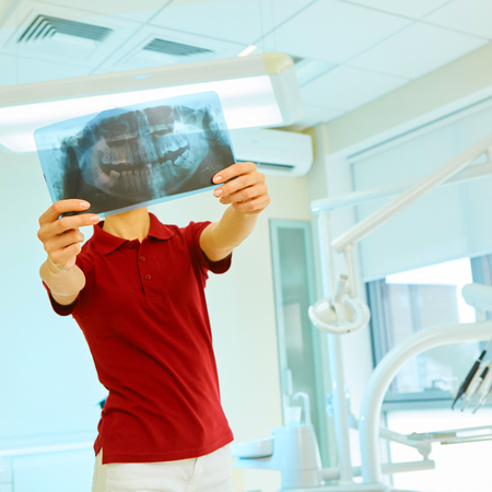picture of female doctor or dentist looking at x-ray