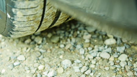 detail of a car wheel and some mud tainting the carの写真素材