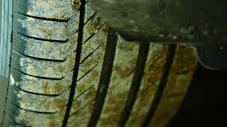 detail of a car wheel and some mud tainting the carの写真素材