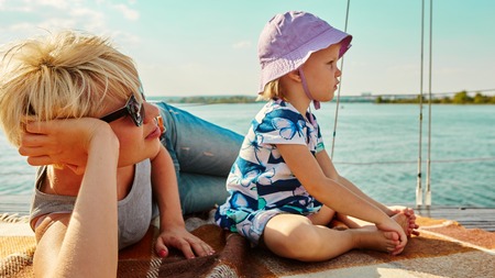 Mother, daughter on yacht or catamaran boat.  Concept of the familyの写真素材