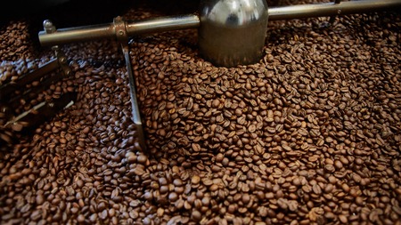 Freshly roasted coffee beans in a coffee roaster. Shallow dofの写真素材