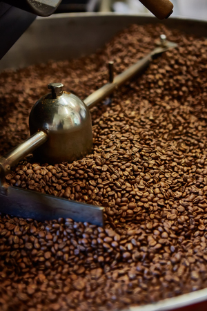 Freshly roasted coffee beans in a coffee roaster. Shallow dofの写真素材