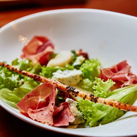 Fresh spring mix salad italian style with prosciutto and Roquefort cheeseの写真素材
