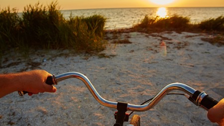 the hands holding handlebar of a bicycleの写真素材