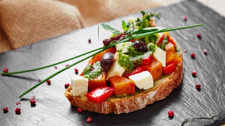 Bruschetta with roasted pumpkin, red pepper,pesto and cheeseの写真素材