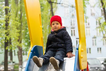 girl playing in a spring park in a playgroundの写真素材