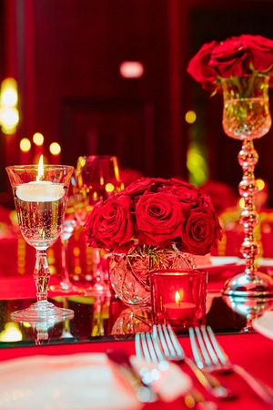Table set for wedding or another catered event dinner in red colorsの写真素材