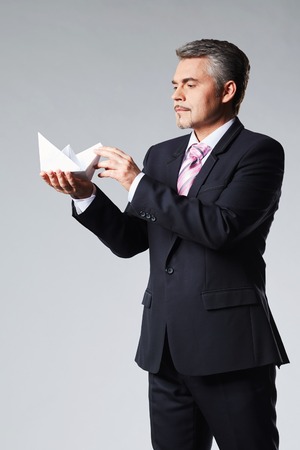 Portrait of businessman holding paper boat. The concept ideaの写真素材