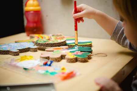 Little female baby painting with colorful paints. selective focusの写真素材