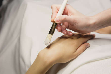 Close up of hands applying cream over table. SPAの写真素材