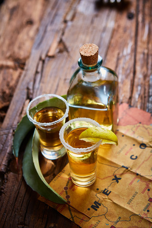 Tequila shot with lime and sea salt on wooden table, selective focusの写真素材