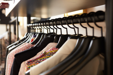 Clothes on hangers in shop. Close up. Shallow dofの写真素材