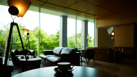 Cup of latte on the table in garden view.の写真素材