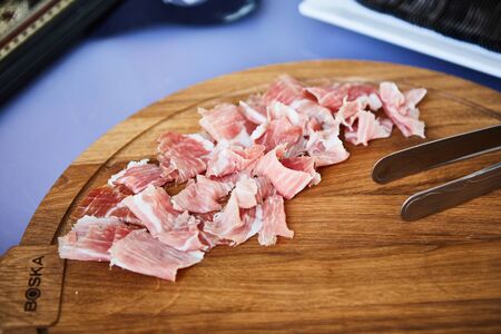 sliced prosciutto on a wooden board. Shallow dofの写真素材