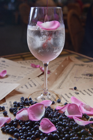 Homemade rose lemonade with ice and blueberriesの写真素材
