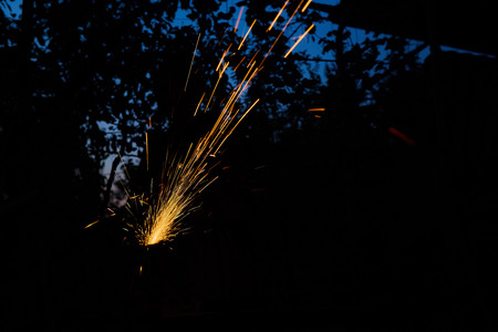 Worker cutting metal with grinder. Sparks while grinding iron.