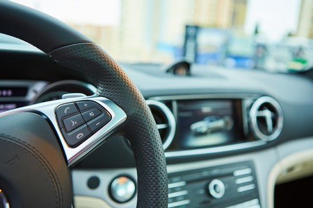 Control buttons on the steering wheel of a car.の写真素材